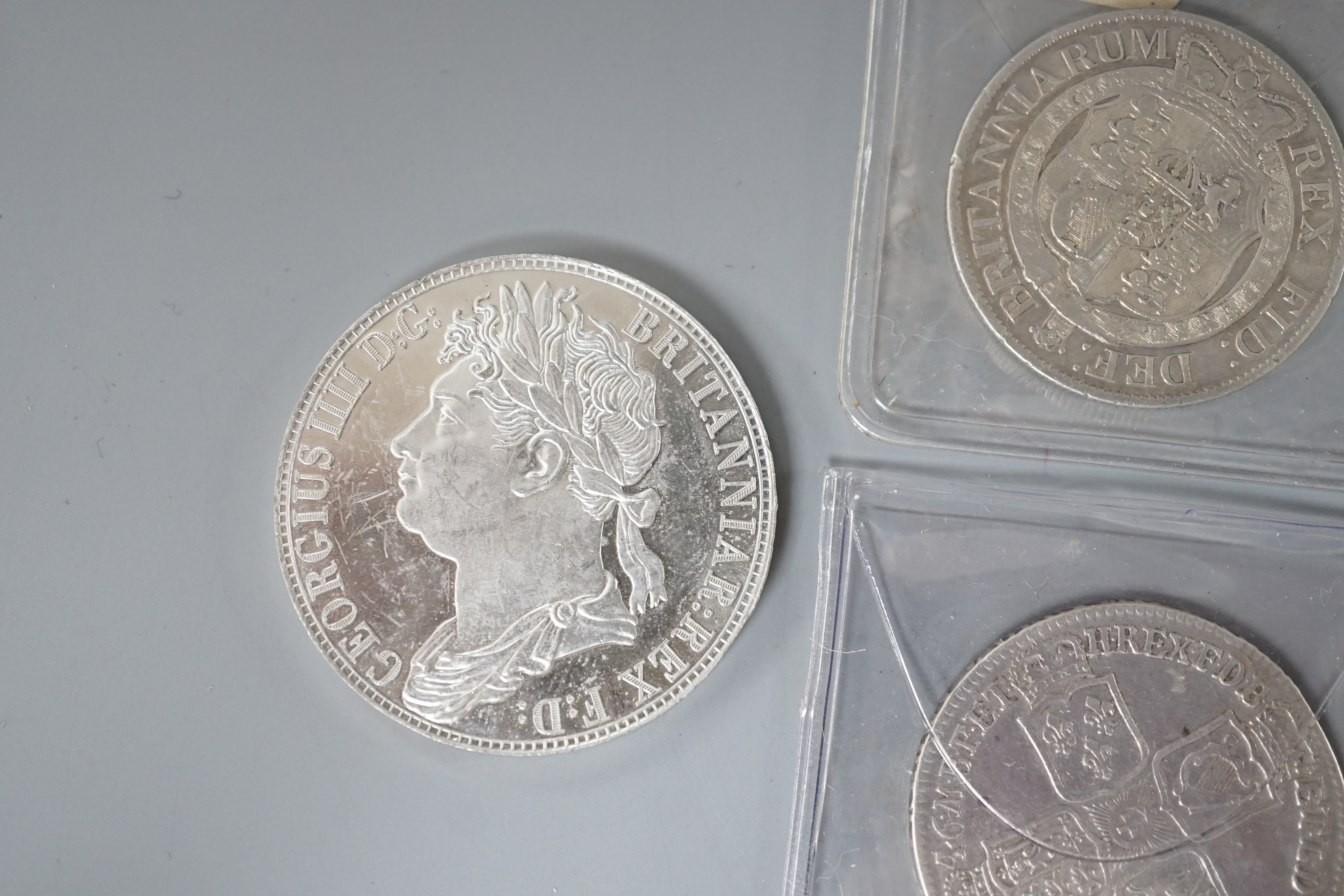 Three Georgian half crowns; 1746, 1818 & 1823 and two other coins.
